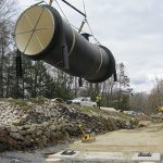 Large Pipe Being Transported Across Worksite