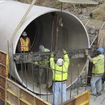 Technicians Working in Large Pipe