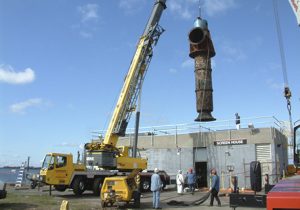 crane hauling old saltwater pump in New Haven, CT